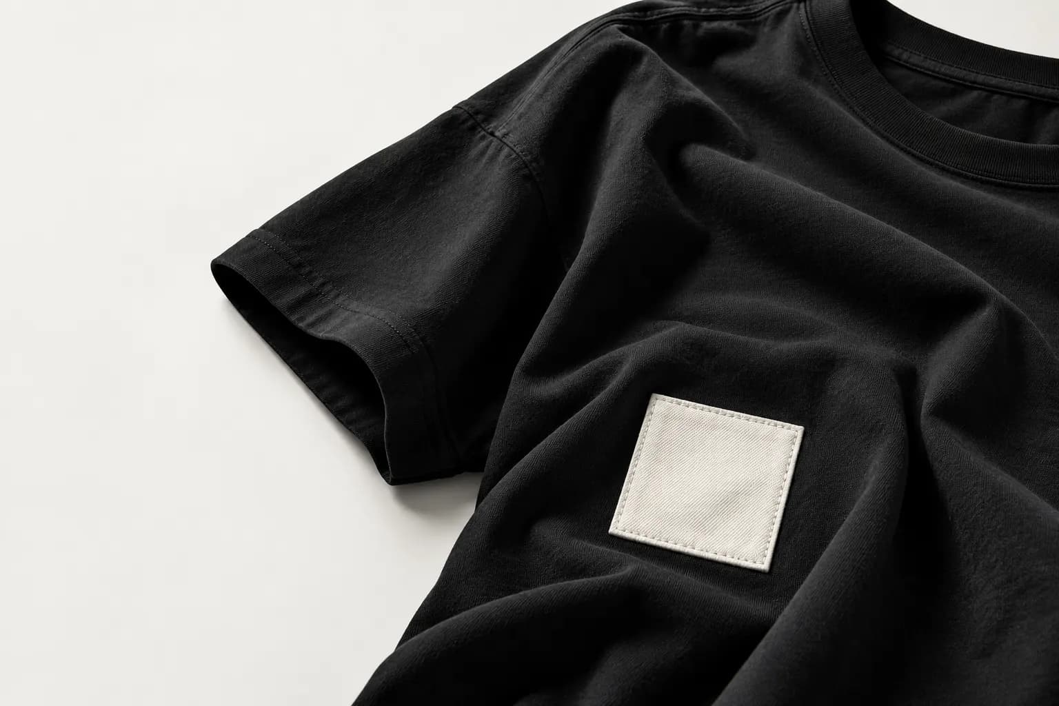 Illustrative study of a black garment and removable textile patch